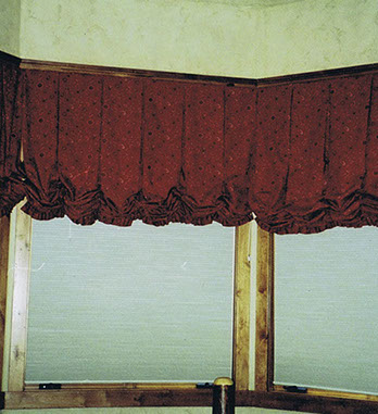 Soft valances  and cornice boards, red shades and wood